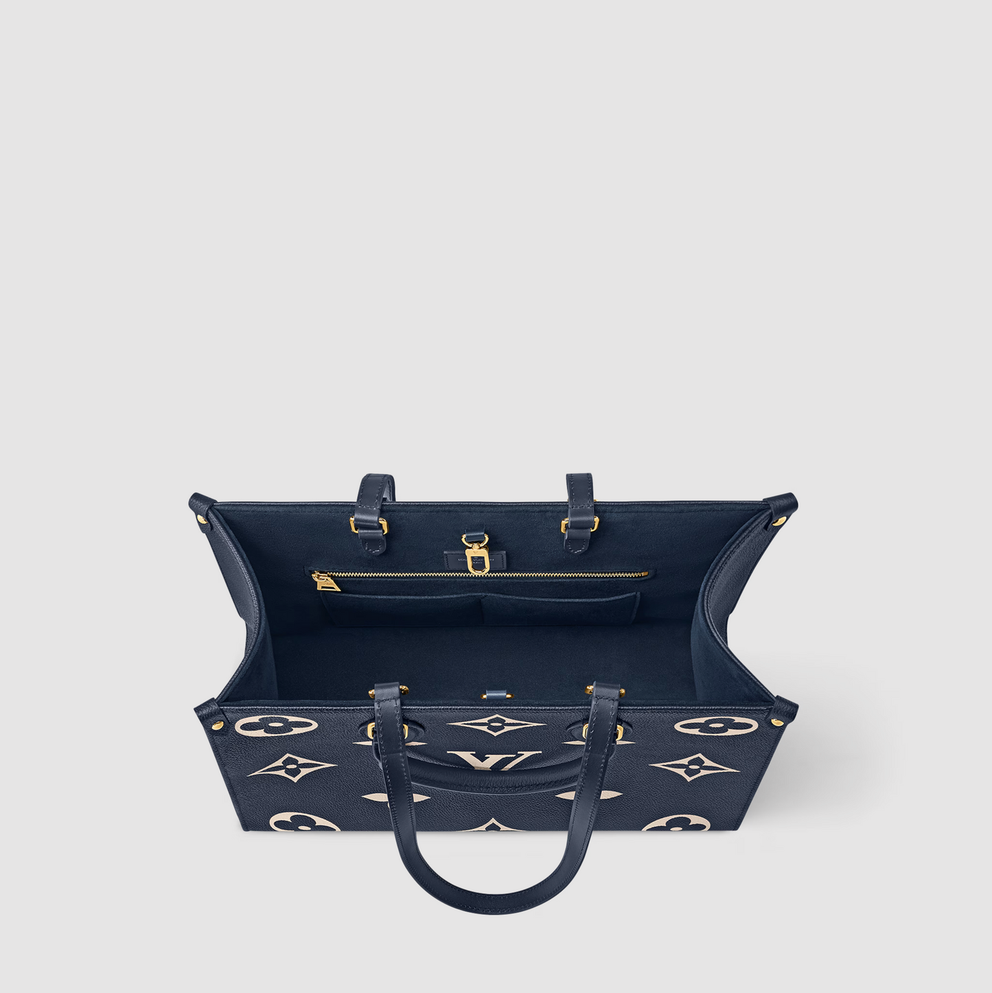 Navy blue handbag with gold accents on a light gray background