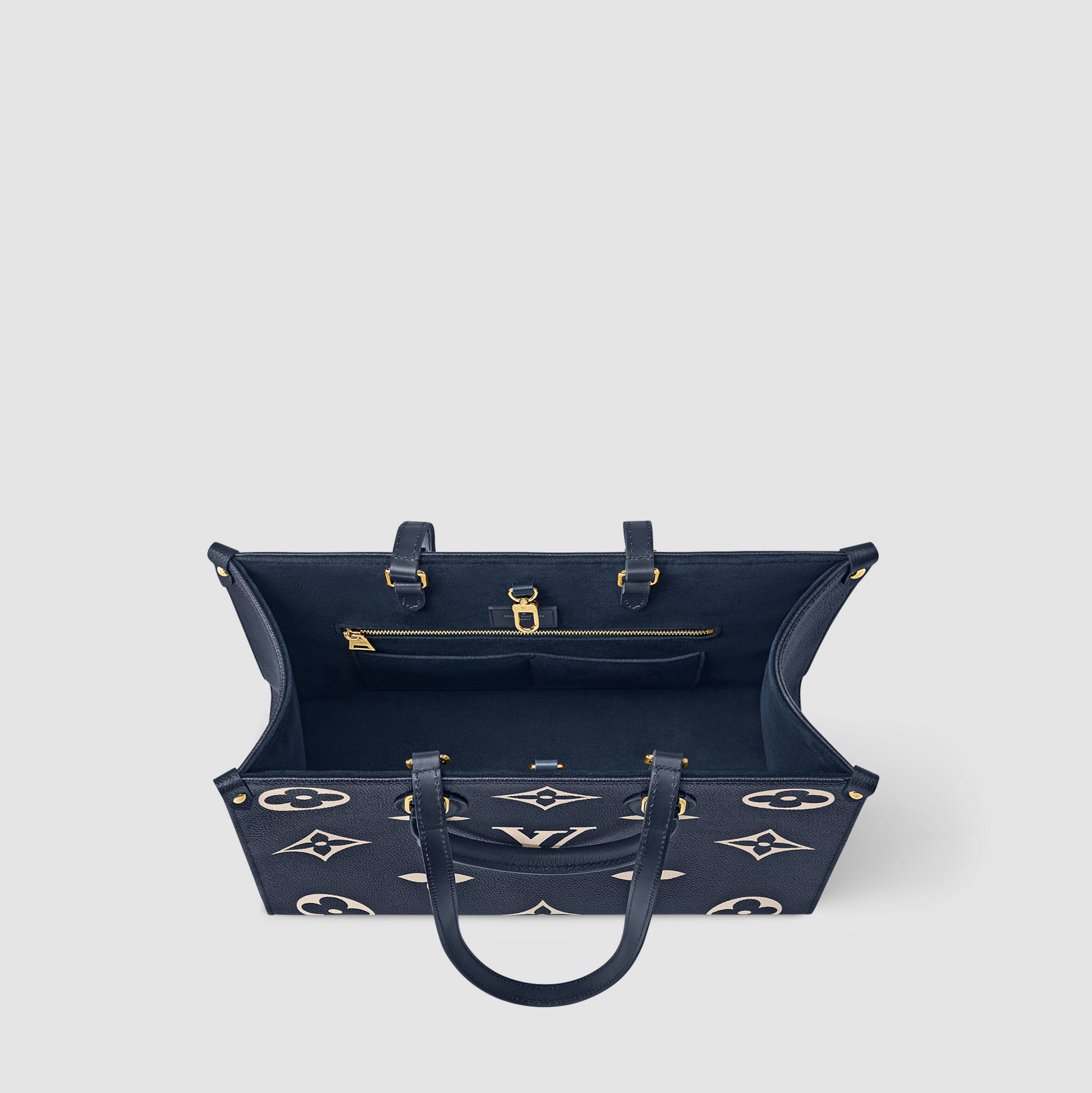 Navy blue handbag with gold accents on a light gray background