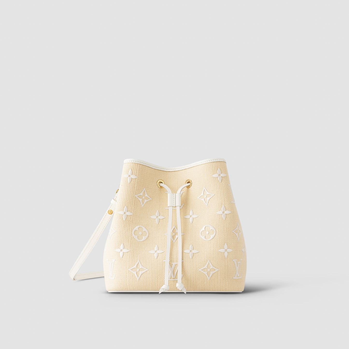 Beige handbag with white monogram pattern on a light gray background