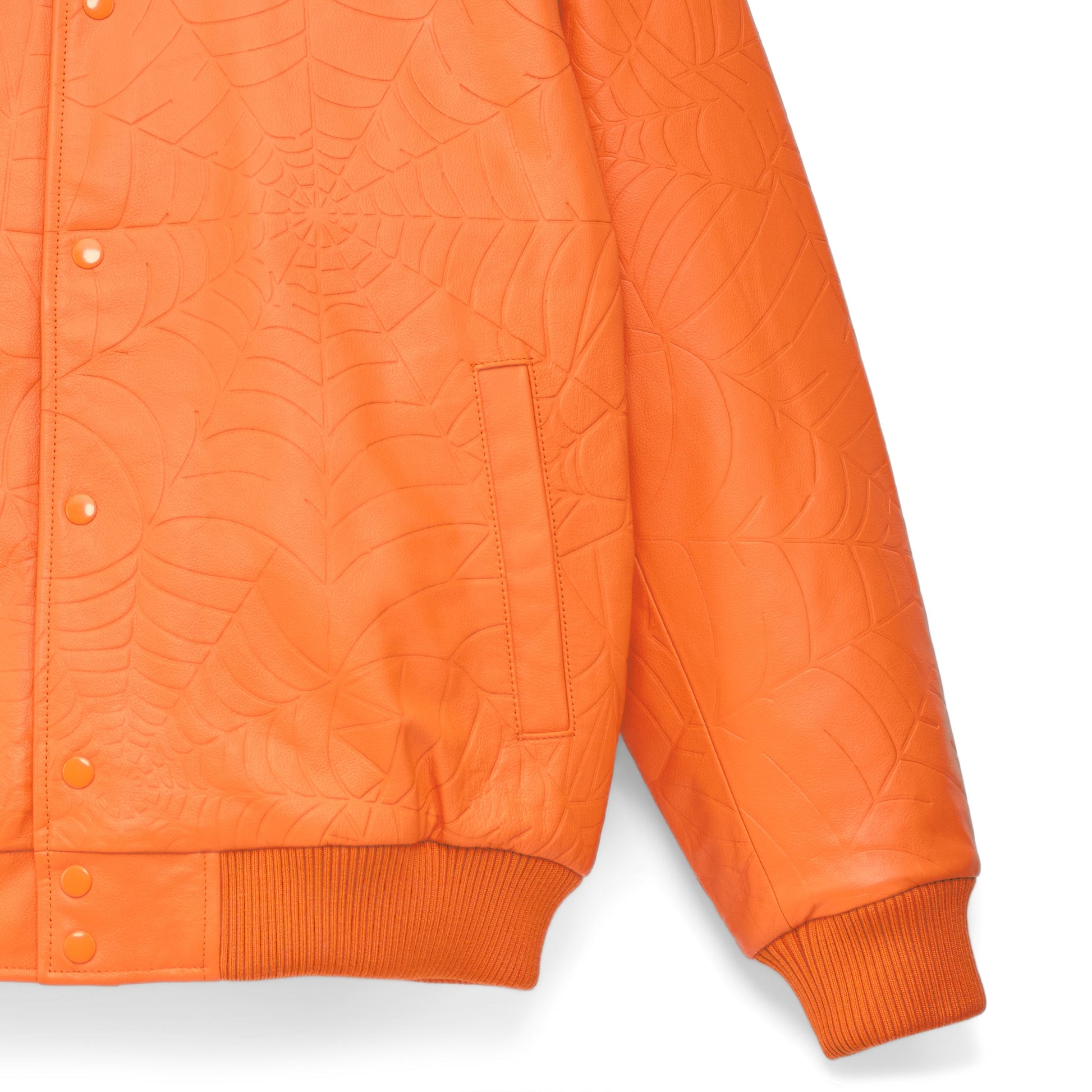 Detail view of debossed web design on SP5DER Debossed Web Leather Jacket in Orange