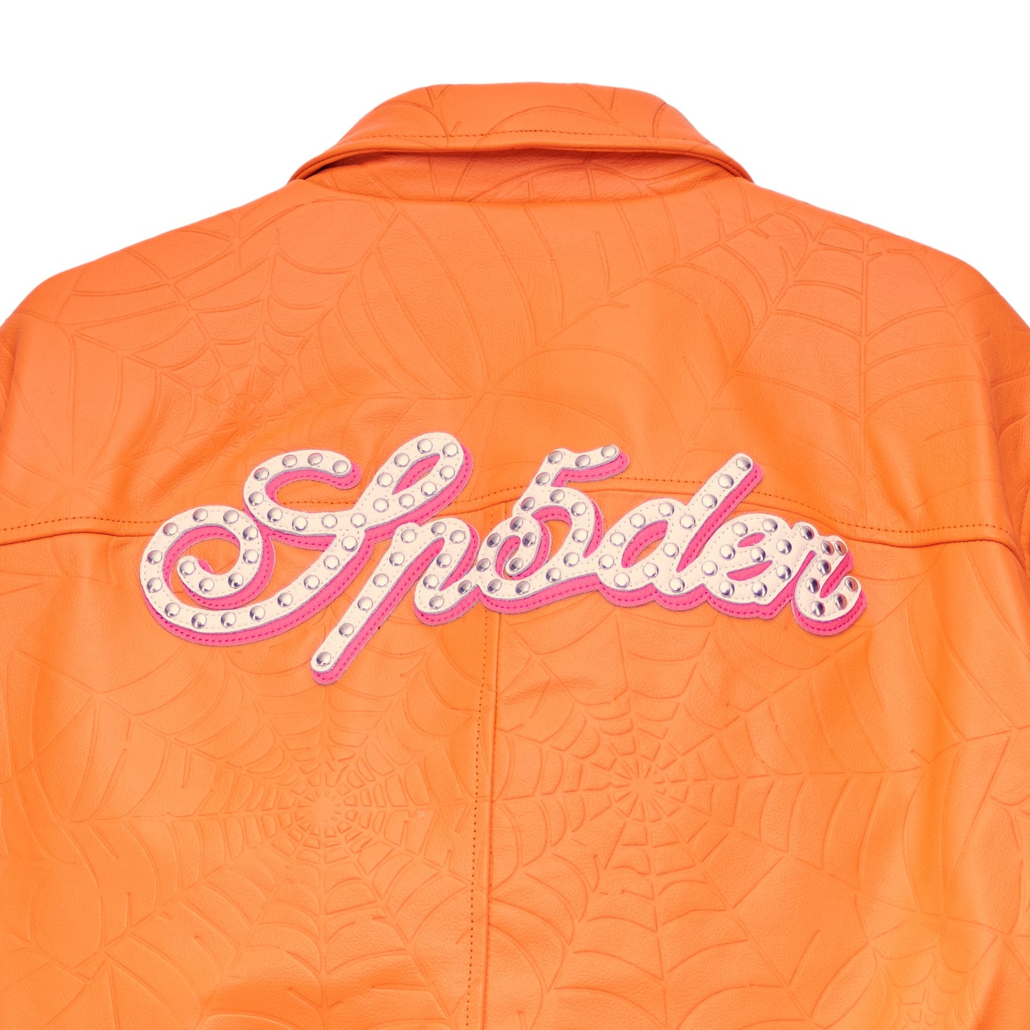 Detail view of studded text on SP5DER Debossed Web Leather Jacket in Orange
