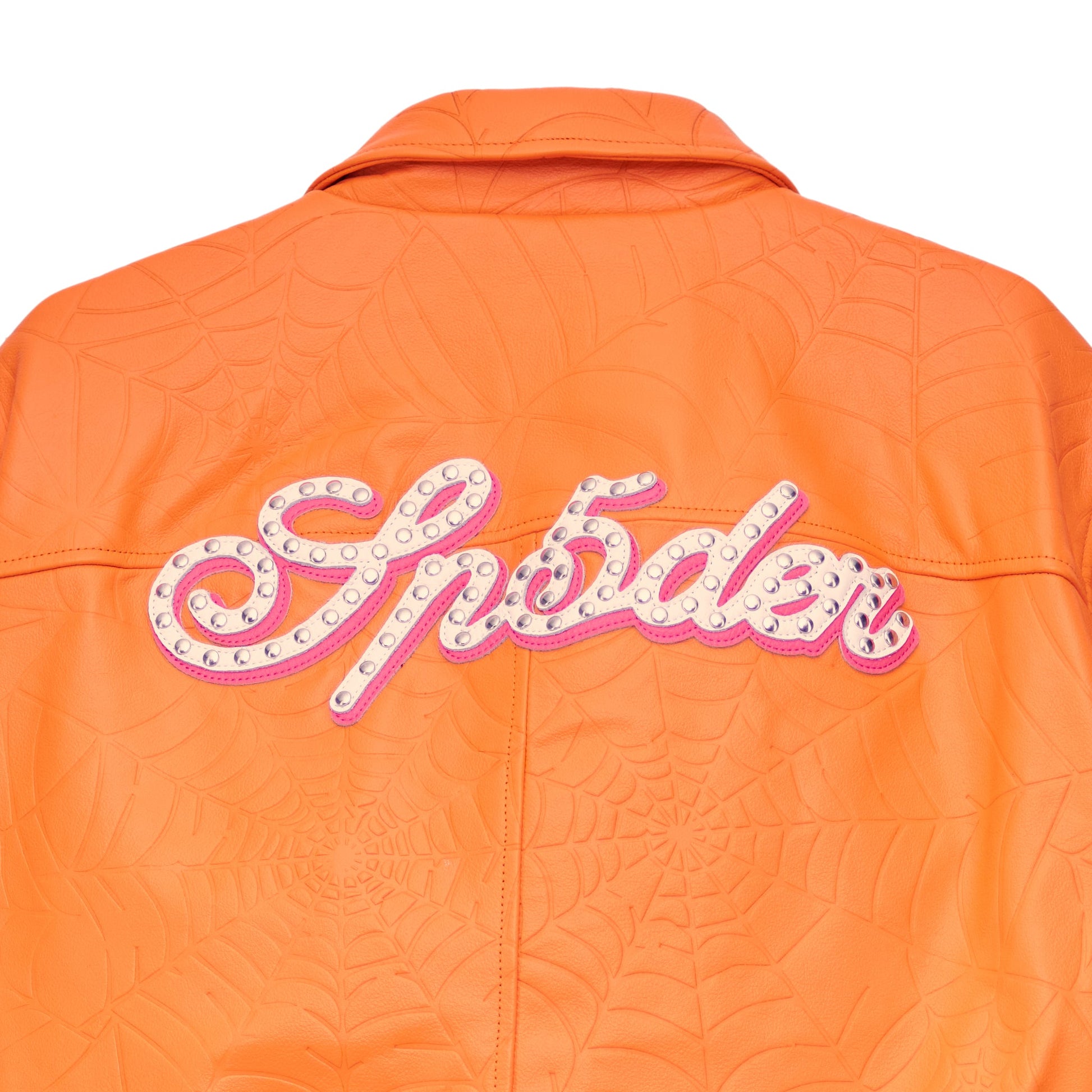 Detail view of studded text on SP5DER Debossed Web Leather Jacket in Orange