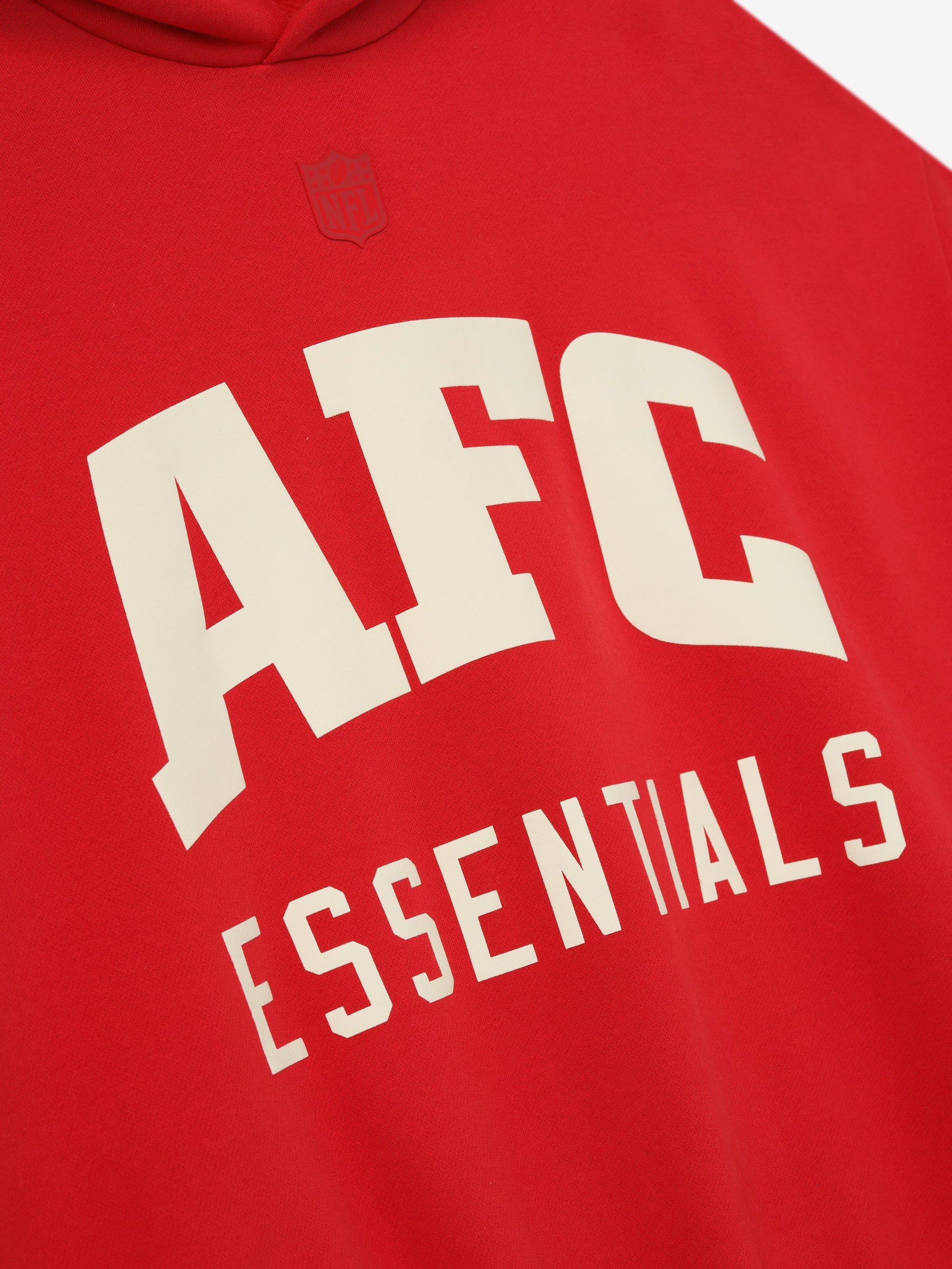 Red hoodie with 'AFC Essentials' text and logo on a gray background