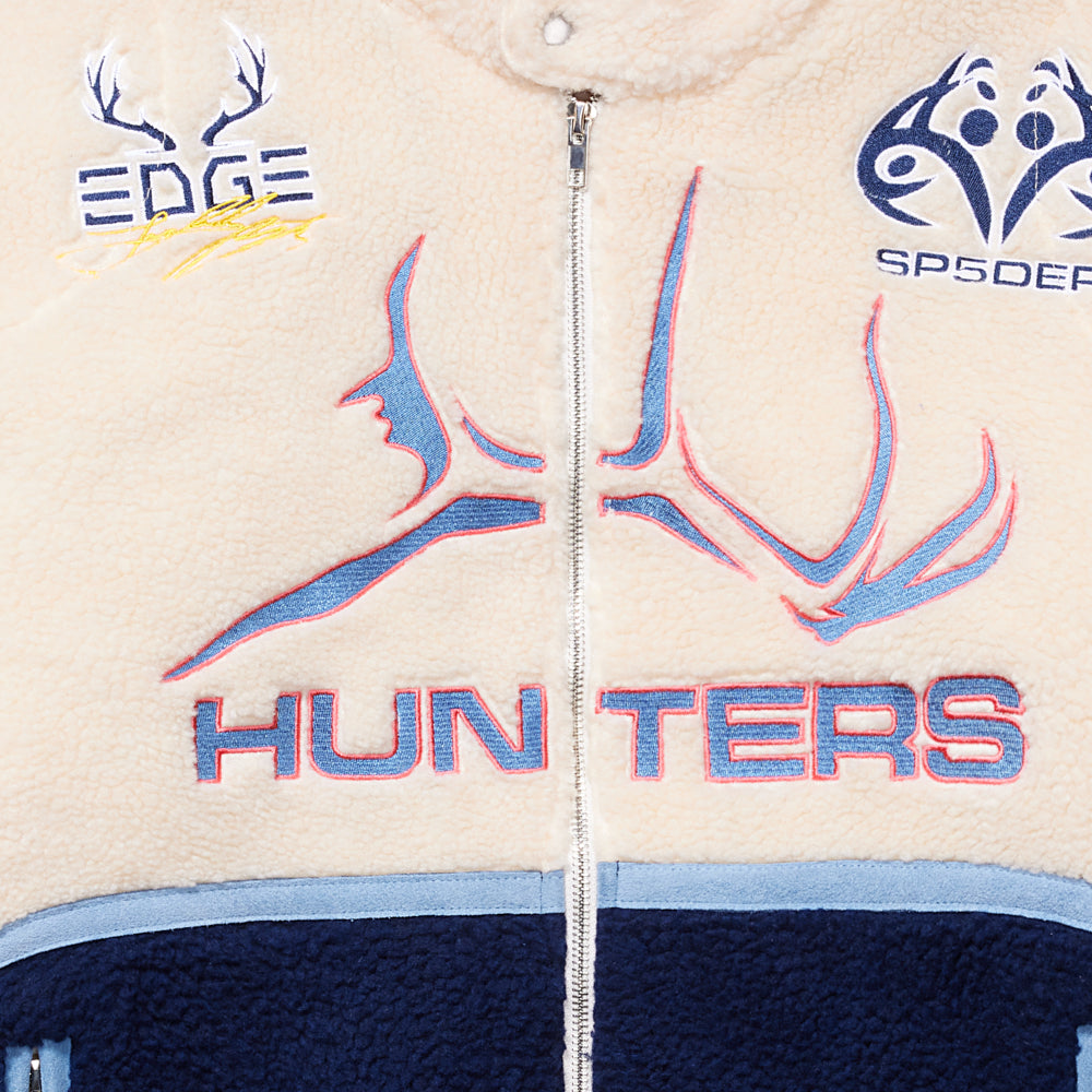 Detail view of leather/suede trim on SP5DER Sherpa Hunter Moto Jacket in Beige