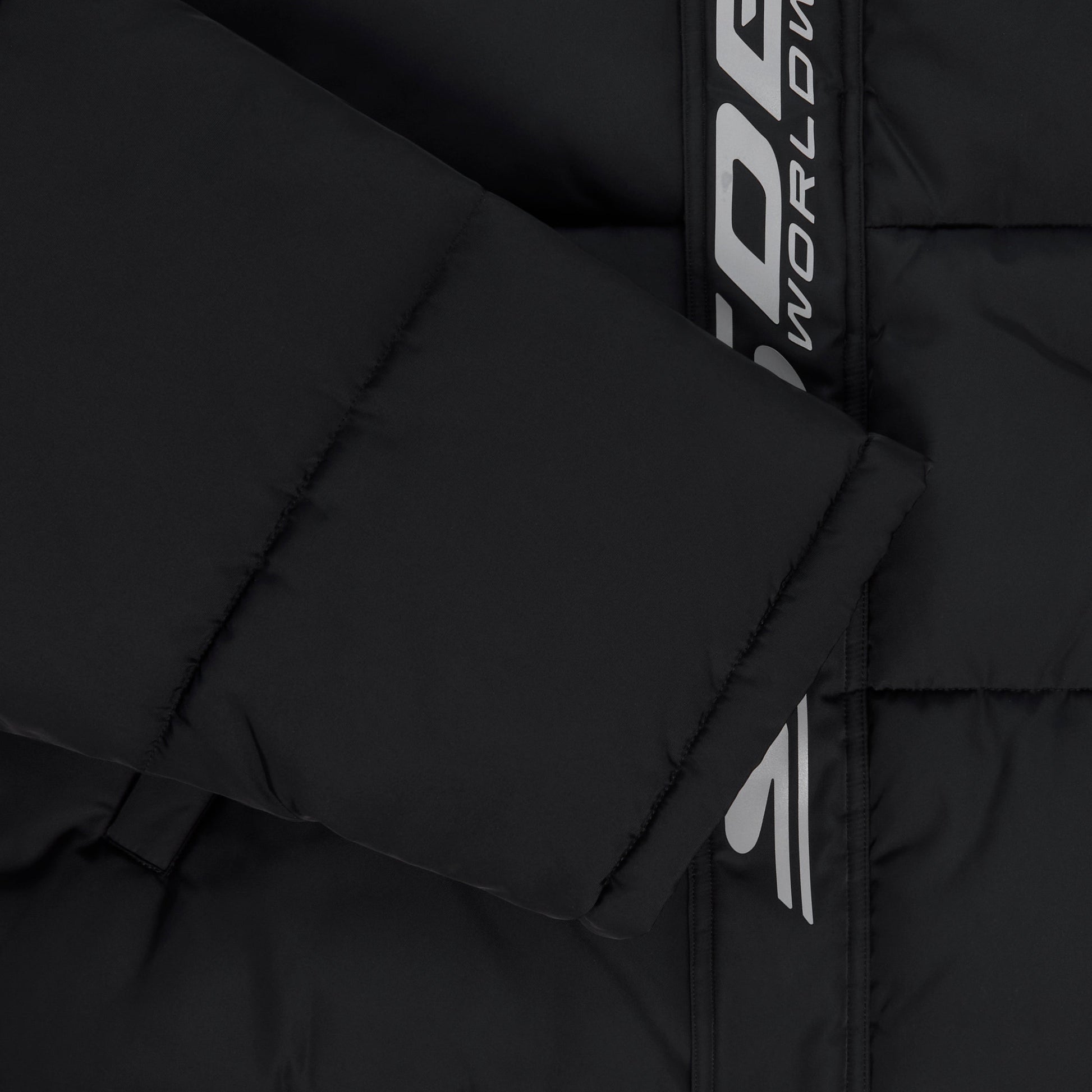 Detail view of reflective text graphic on SP5DER Trackhawk Puffer Jacket in Black