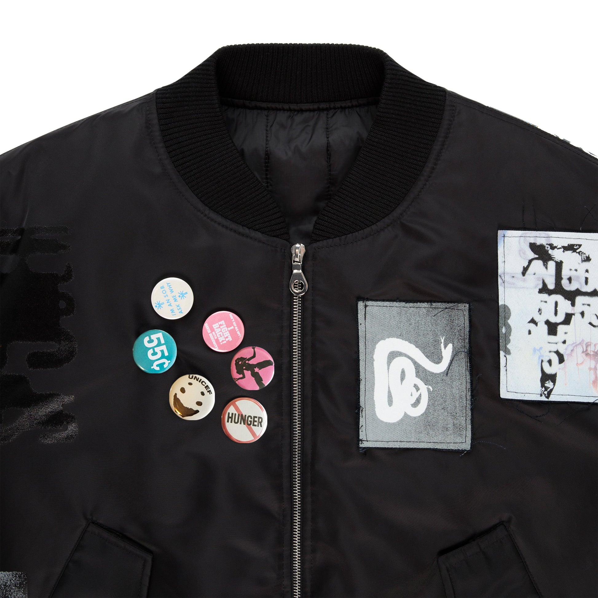 Detail view of custom patches on SP5DER Vet Bomber Jacket in Black