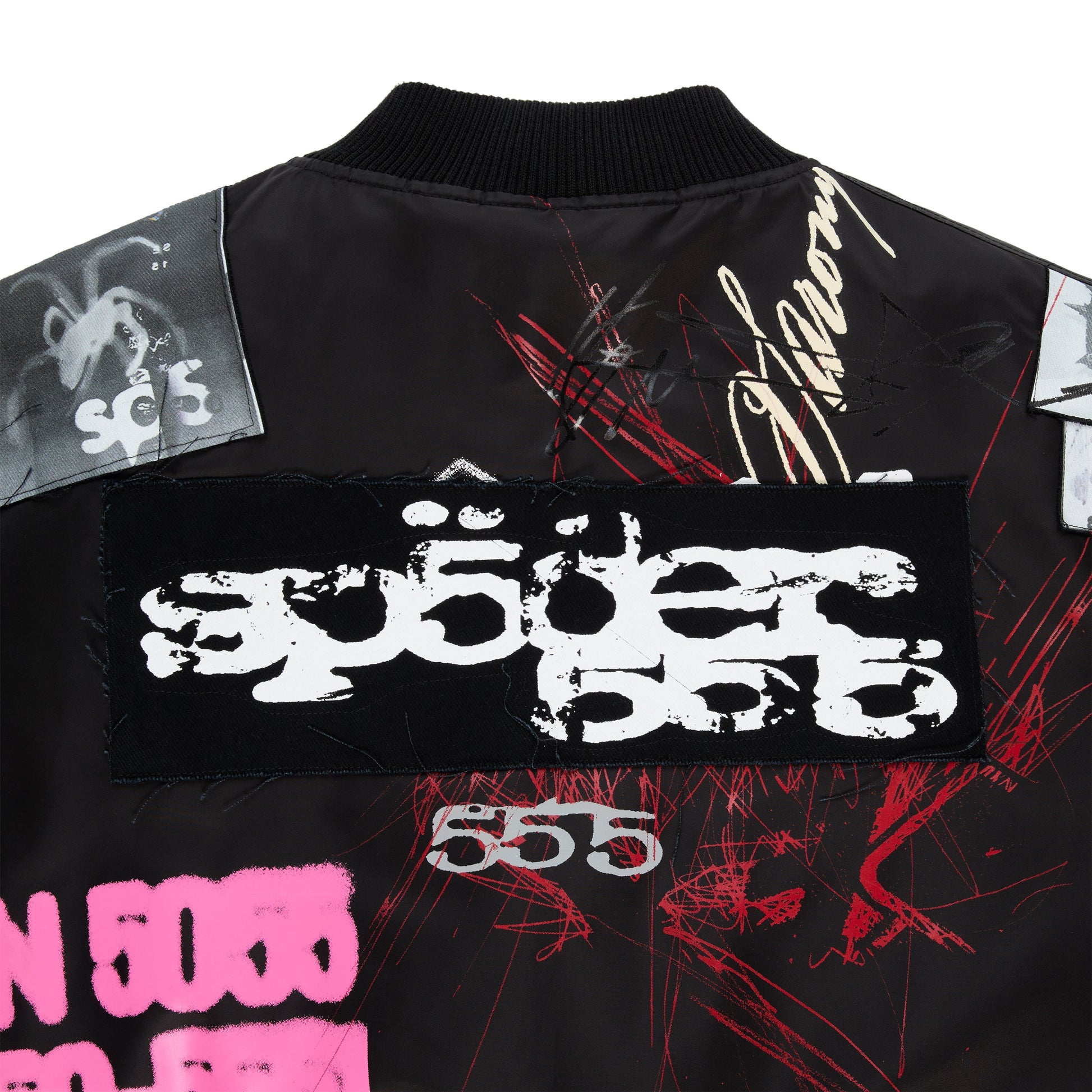Detail view of pins on chest of SP5DER Vet Bomber Jacket in Black