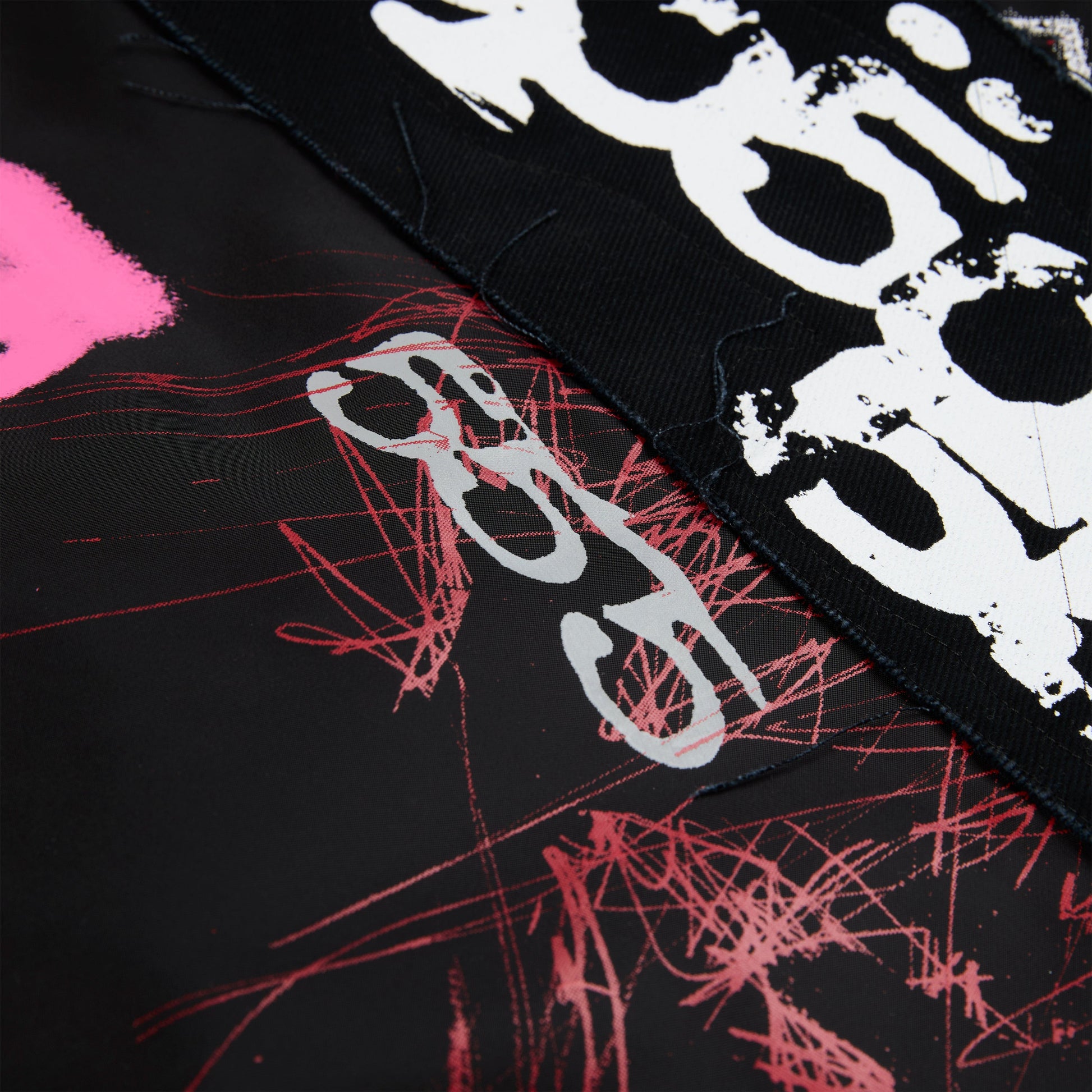 Detail view of embroidered sleeve text on SP5DER Vet Bomber Jacket in Black