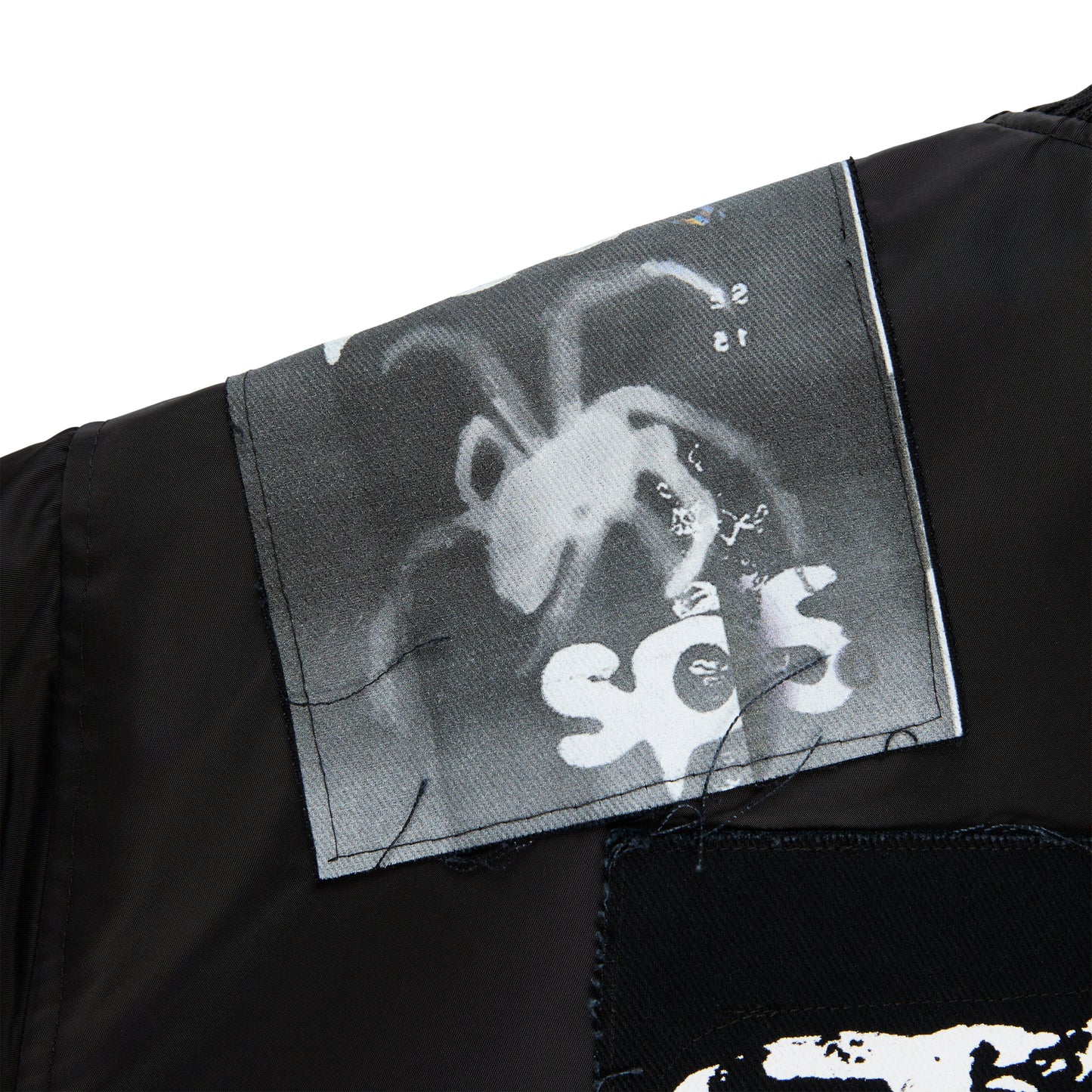 Detail view of rib-knit collar and cuffs on SP5DER Vet Bomber Jacket in Black