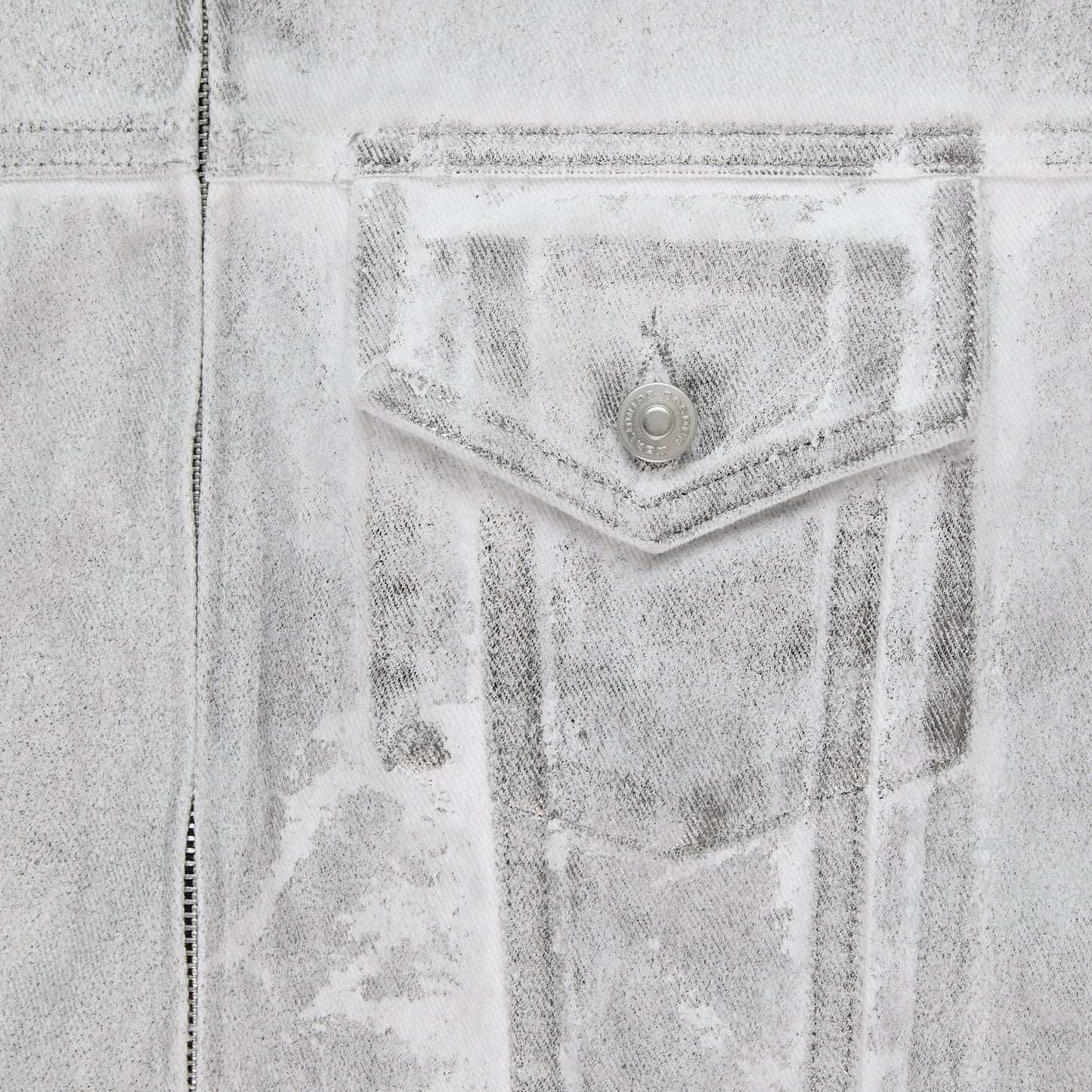 Detail view of hem pocket on SP5DER Platinum Trucker Jacket in Grey