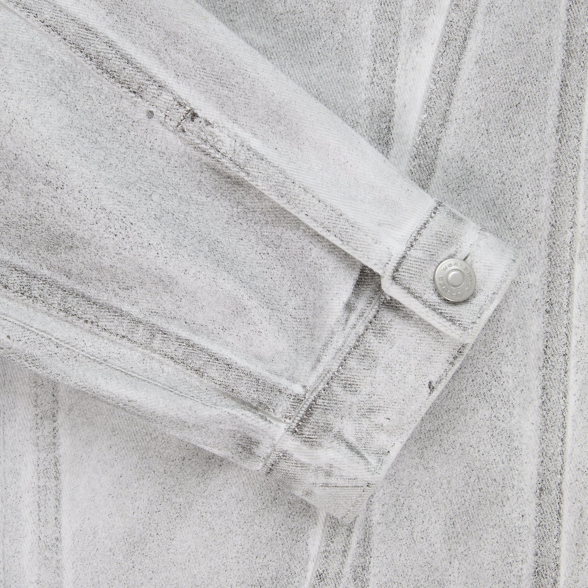 Side view of SP5DER Platinum Trucker Jacket in Grey