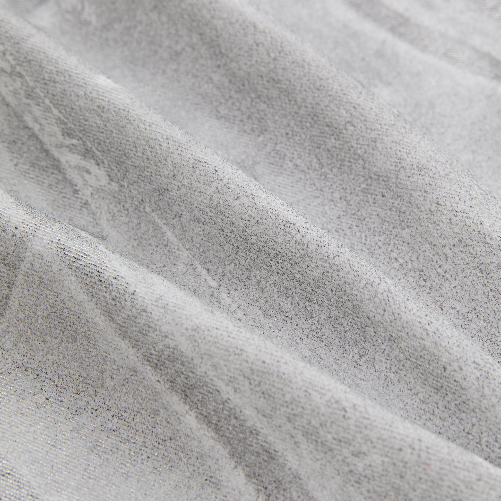 Detail view of embroidered logo on SP5DER Platinum Trucker Jacket in Grey