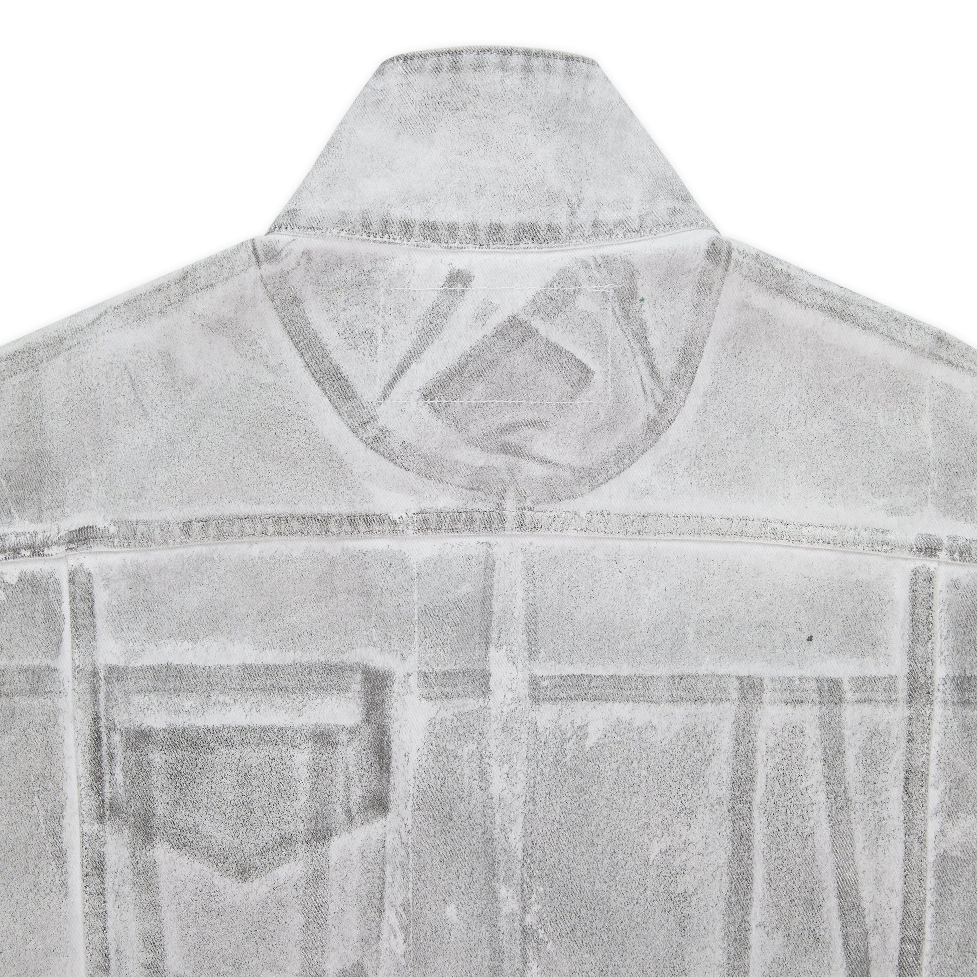 Detail view of branded leather back patch on SP5DER Platinum Trucker Jacket in Grey