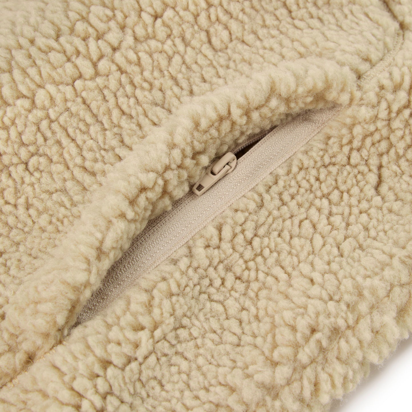 Detail view of narrow front opening on SP5DER Teddy Fleece Zip-Up in Brown