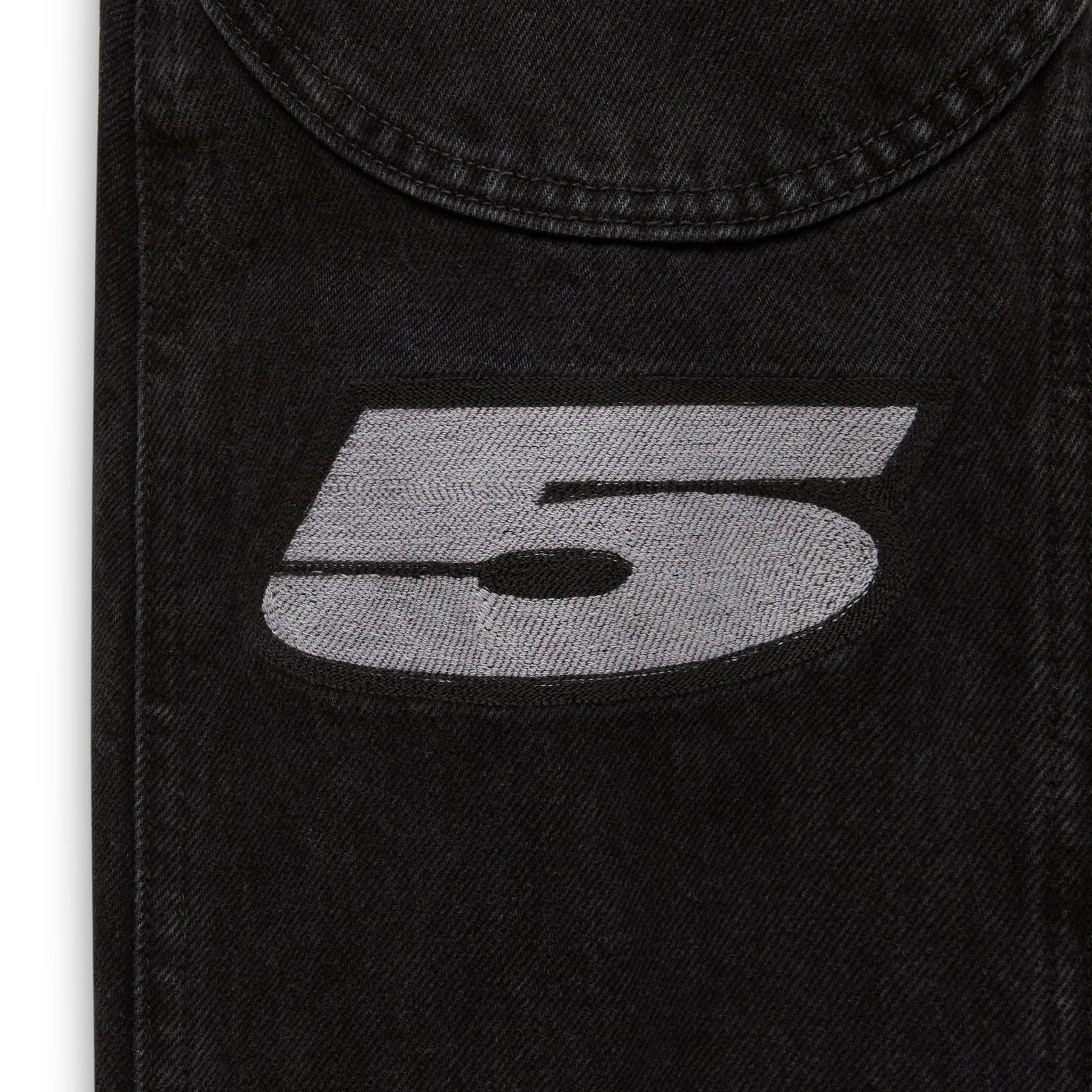 Detail view of sleeve cuff embroidery on Motorsport Denim Jacket in Black