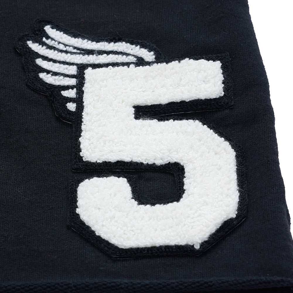 Detail view of chenille patch on SP5DER Cut Sweatshort in Black
