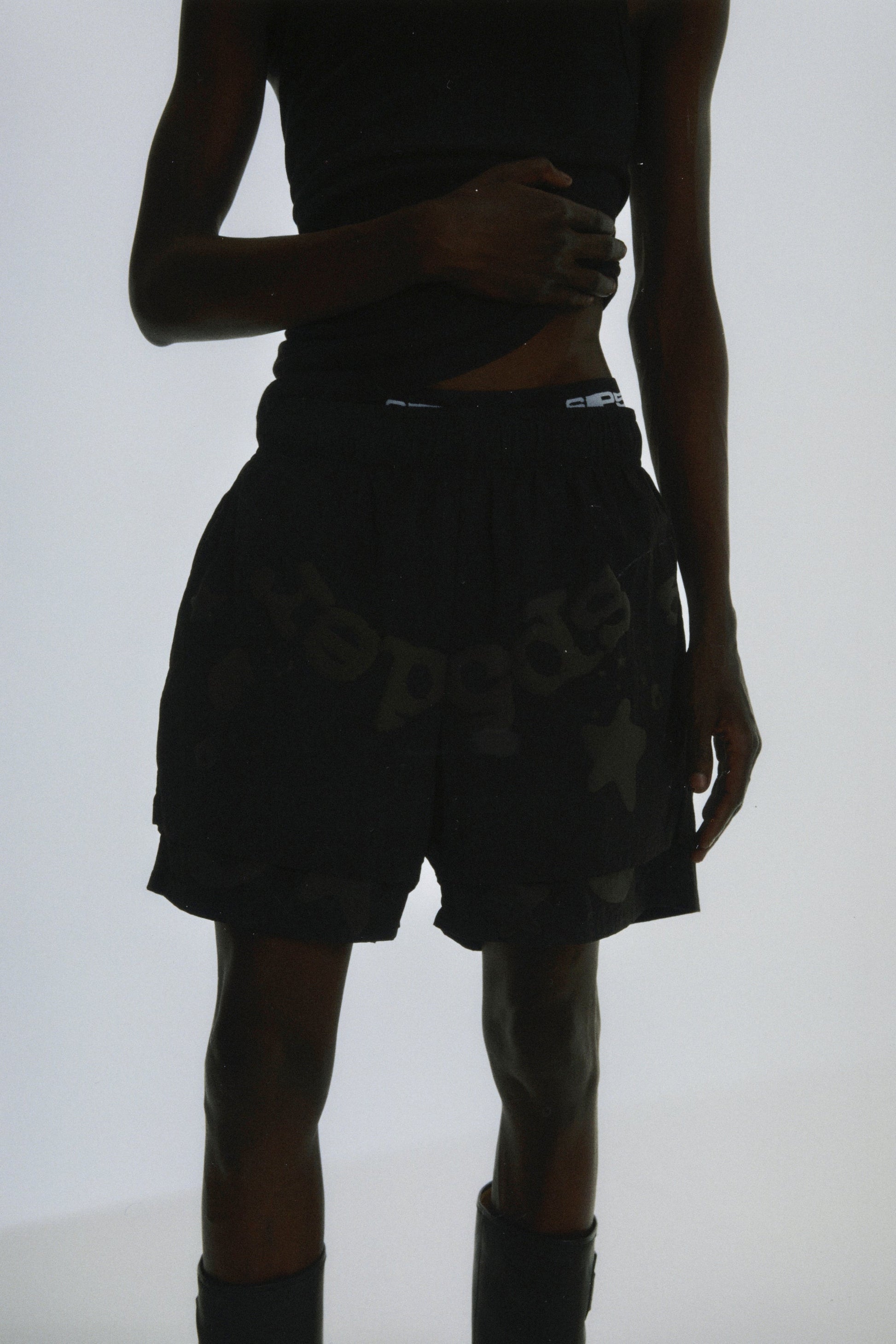 Close-up view of SP5DER Beluga Double Layer Short in Black