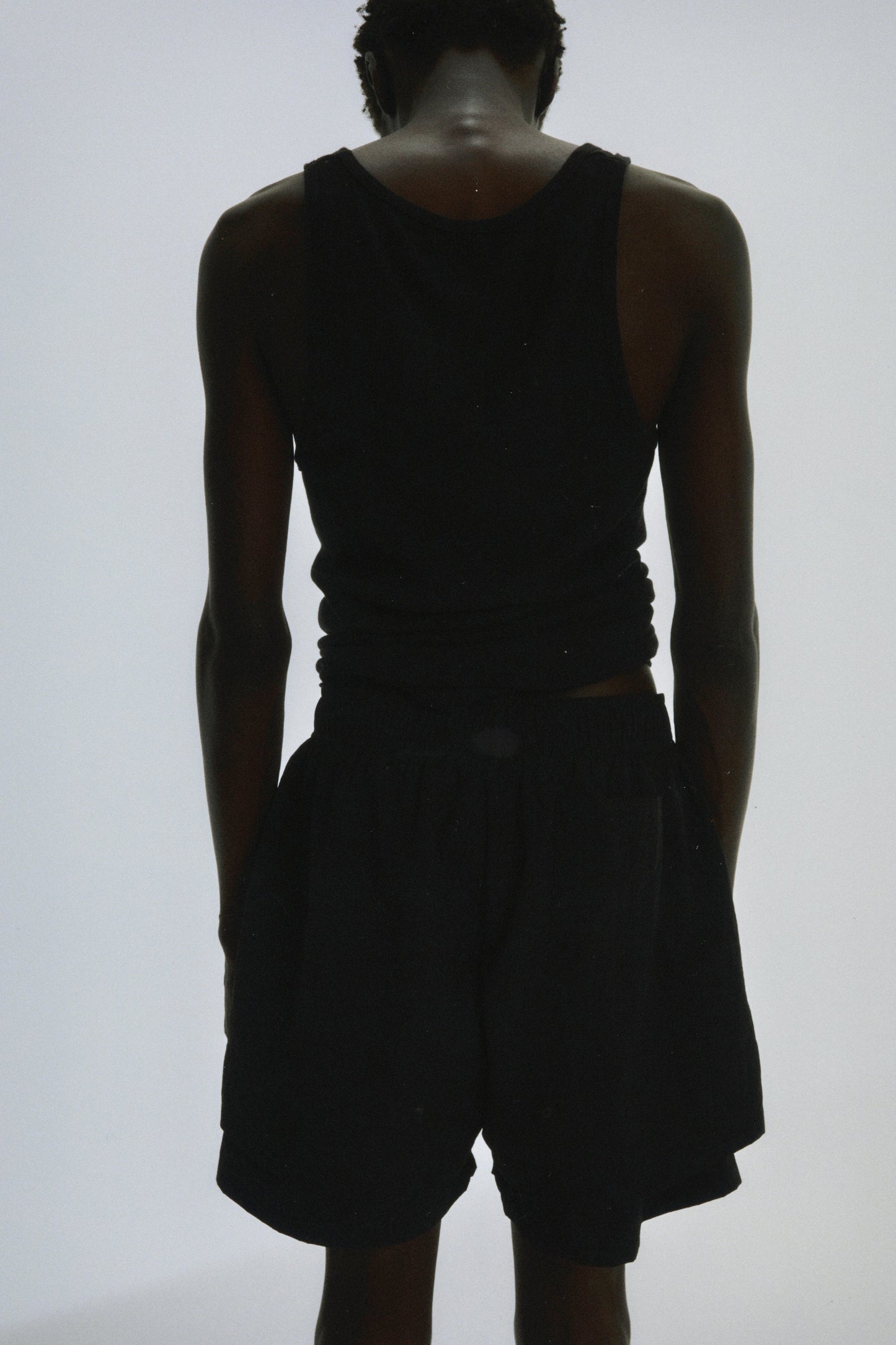 Folded flat view of SP5DER Beluga Double Layer Short in Black