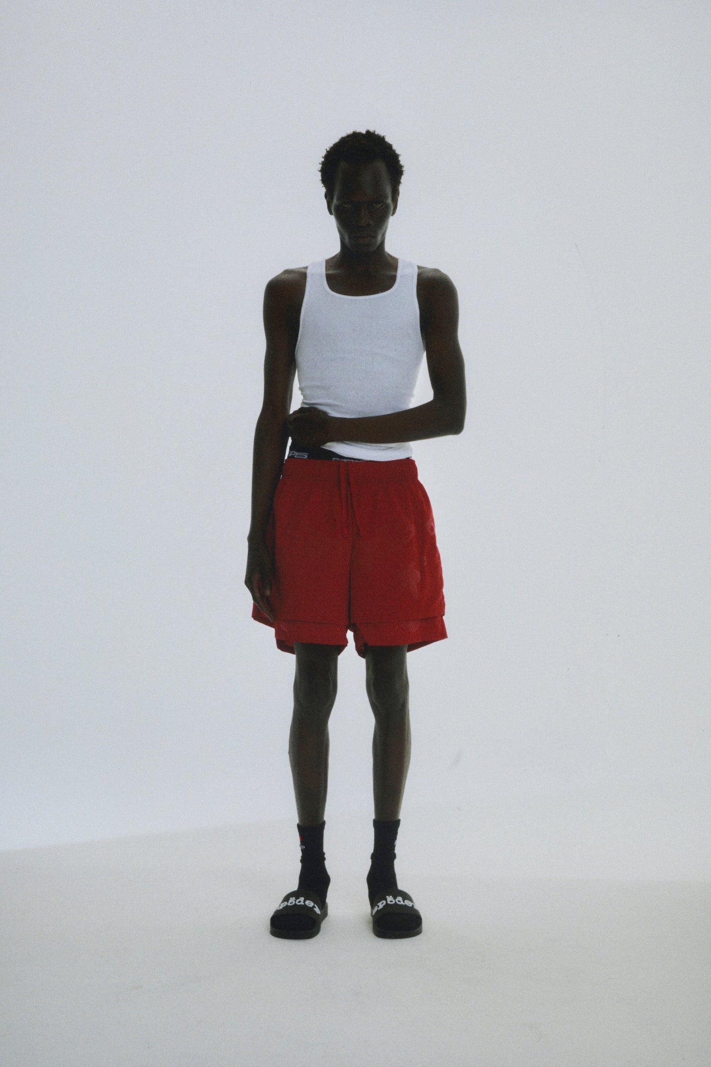 Detail view of back pocket on SP5DER short in Red