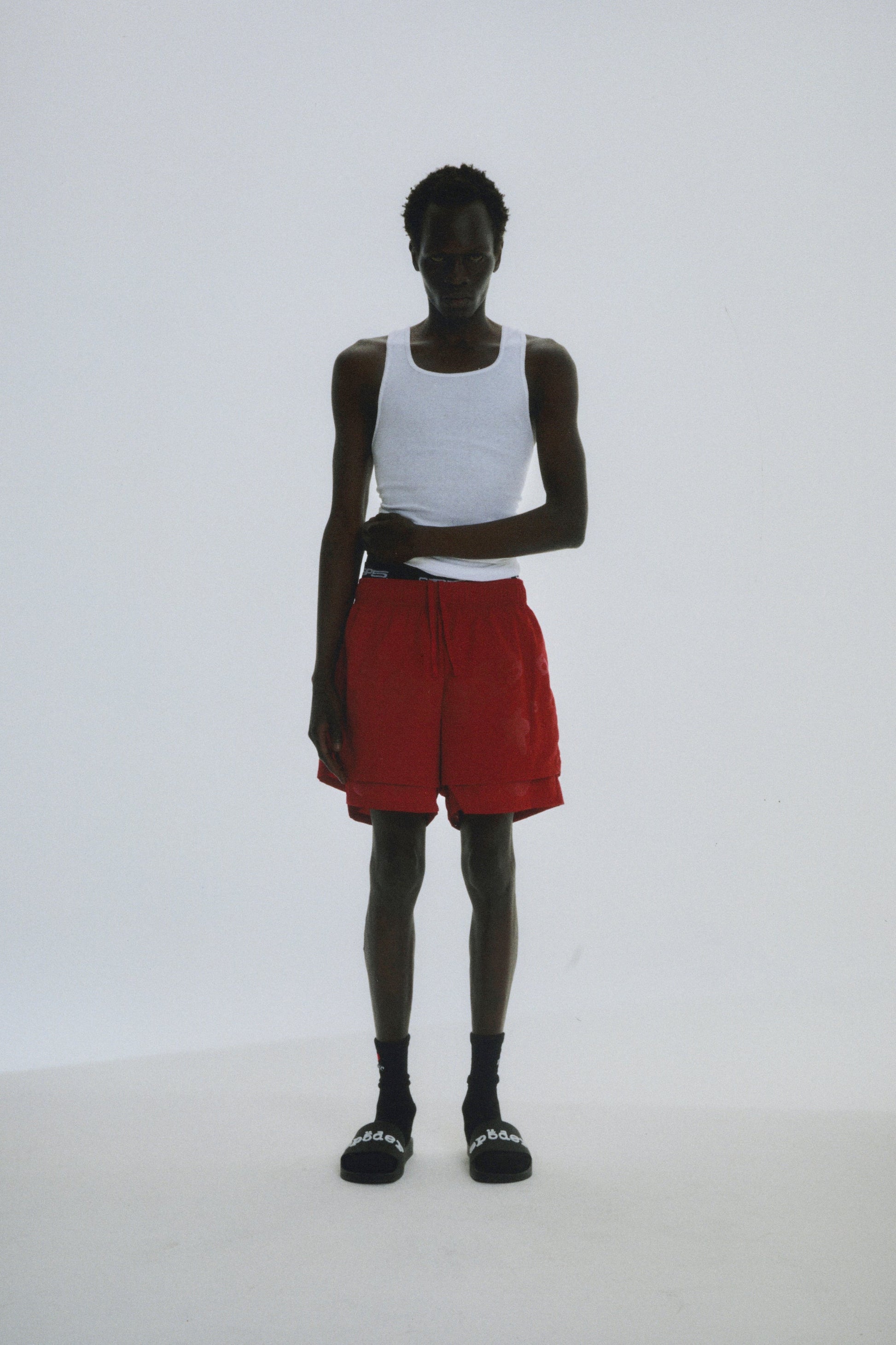 Detail view of back pocket on SP5DER short in Red