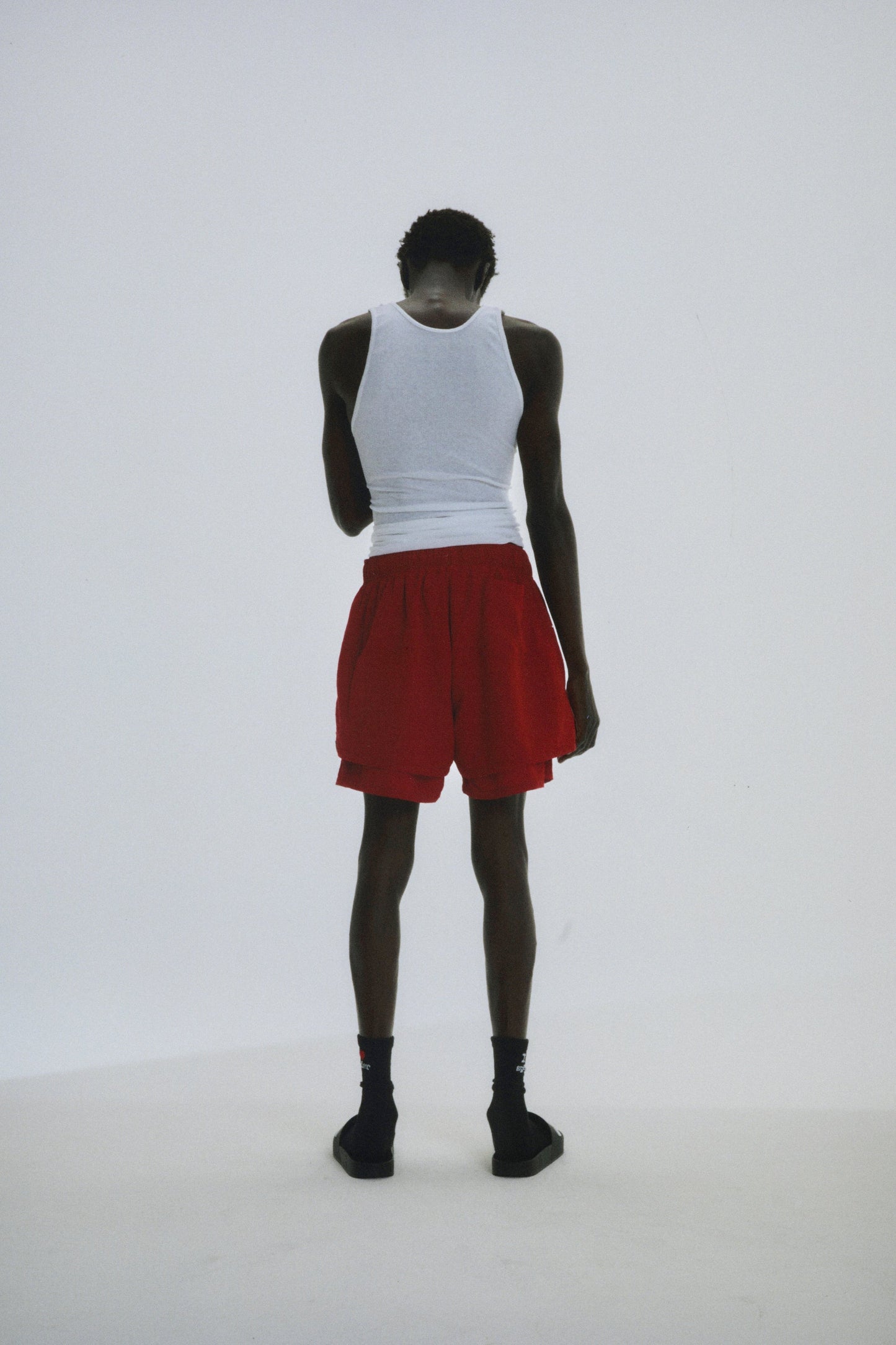 Close-up view of SP5DER Beluga Double Layer Short in Red