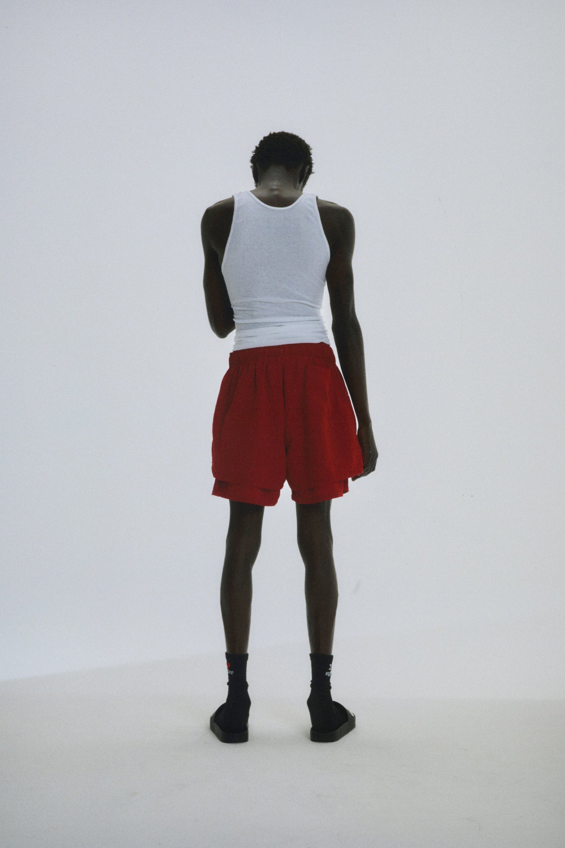 Close-up view of SP5DER Beluga Double Layer Short in Red