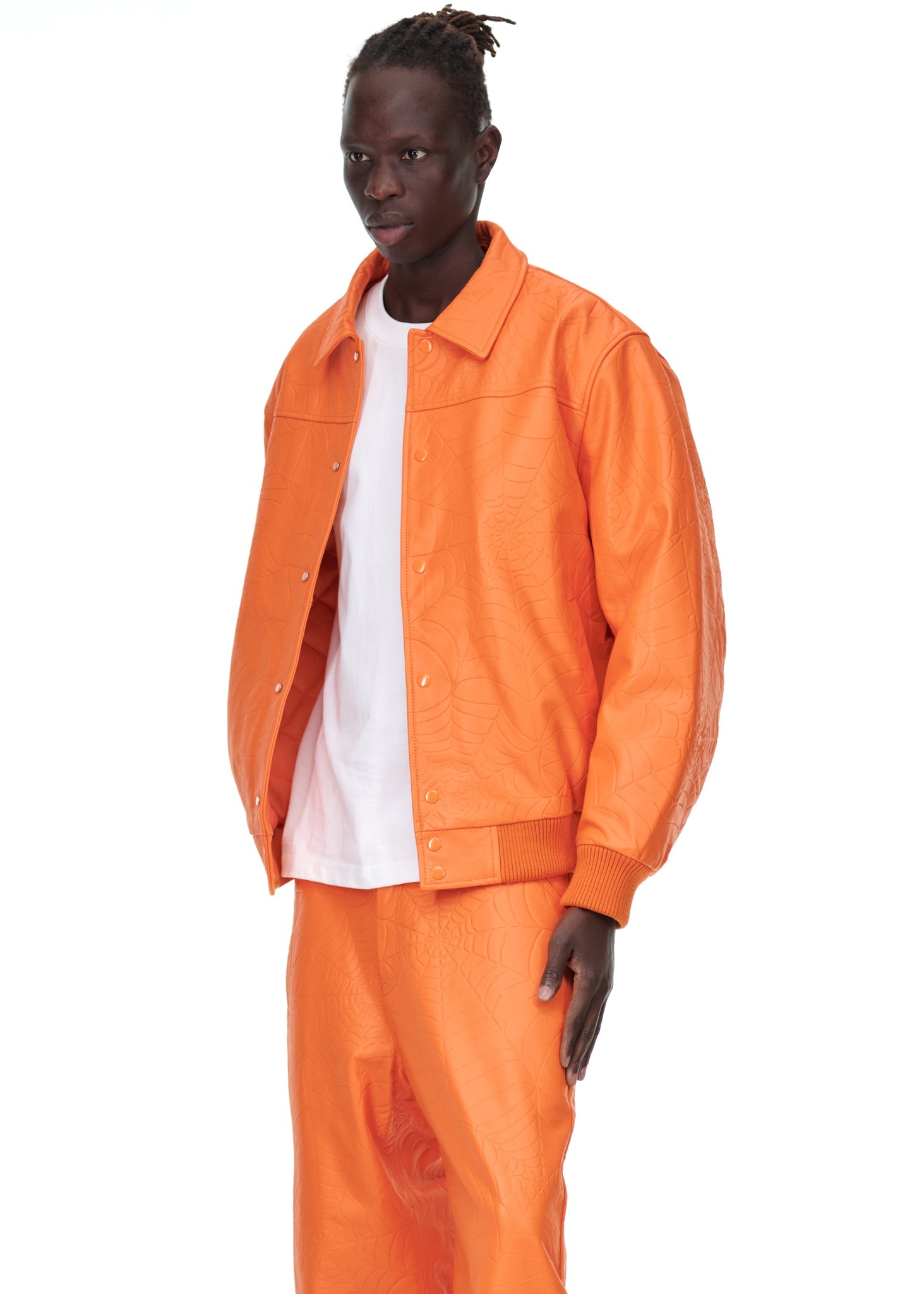 Close-up view of cuffs on SP5DER Debossed Web Leather Jacket in Orange