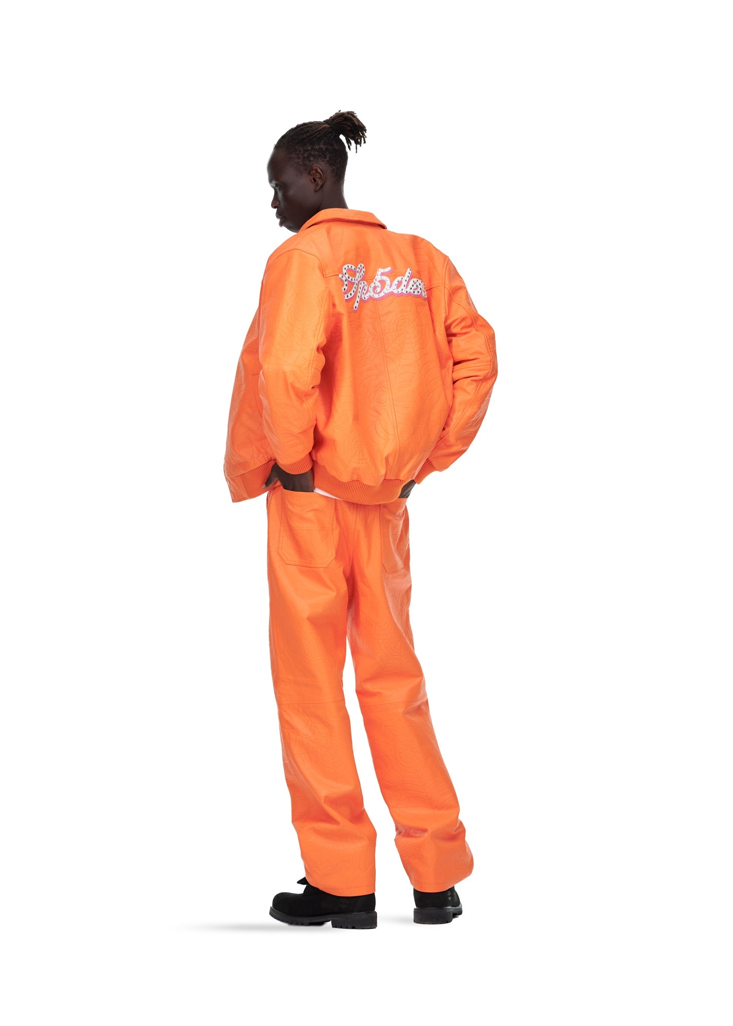 Styled full look view of SP5DER Debossed Web Leather Jacket in Orange
