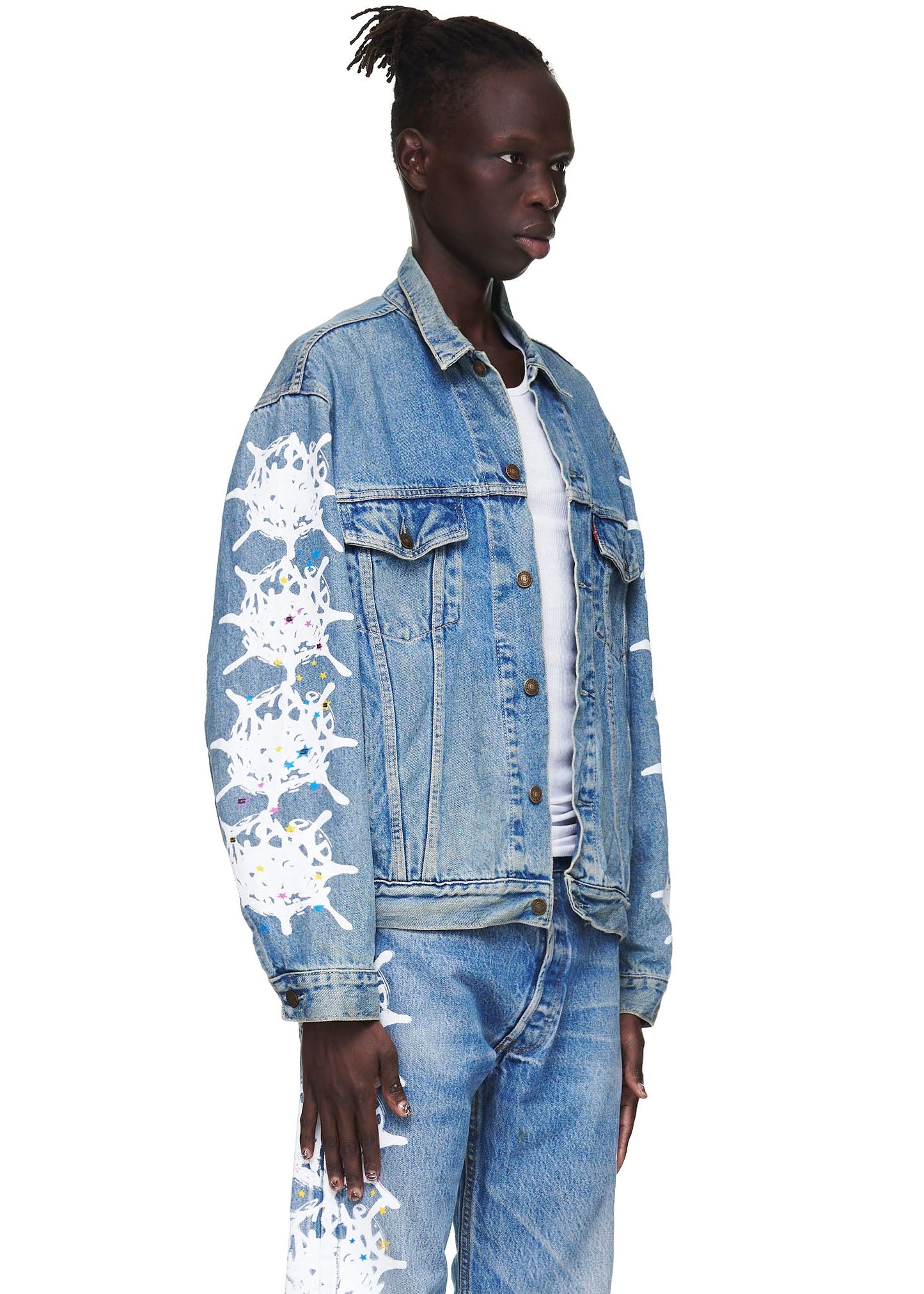 Detail view of white contrast web on sleeve of SP5DER Vintage Web Denim Trucker Jacket in Blue