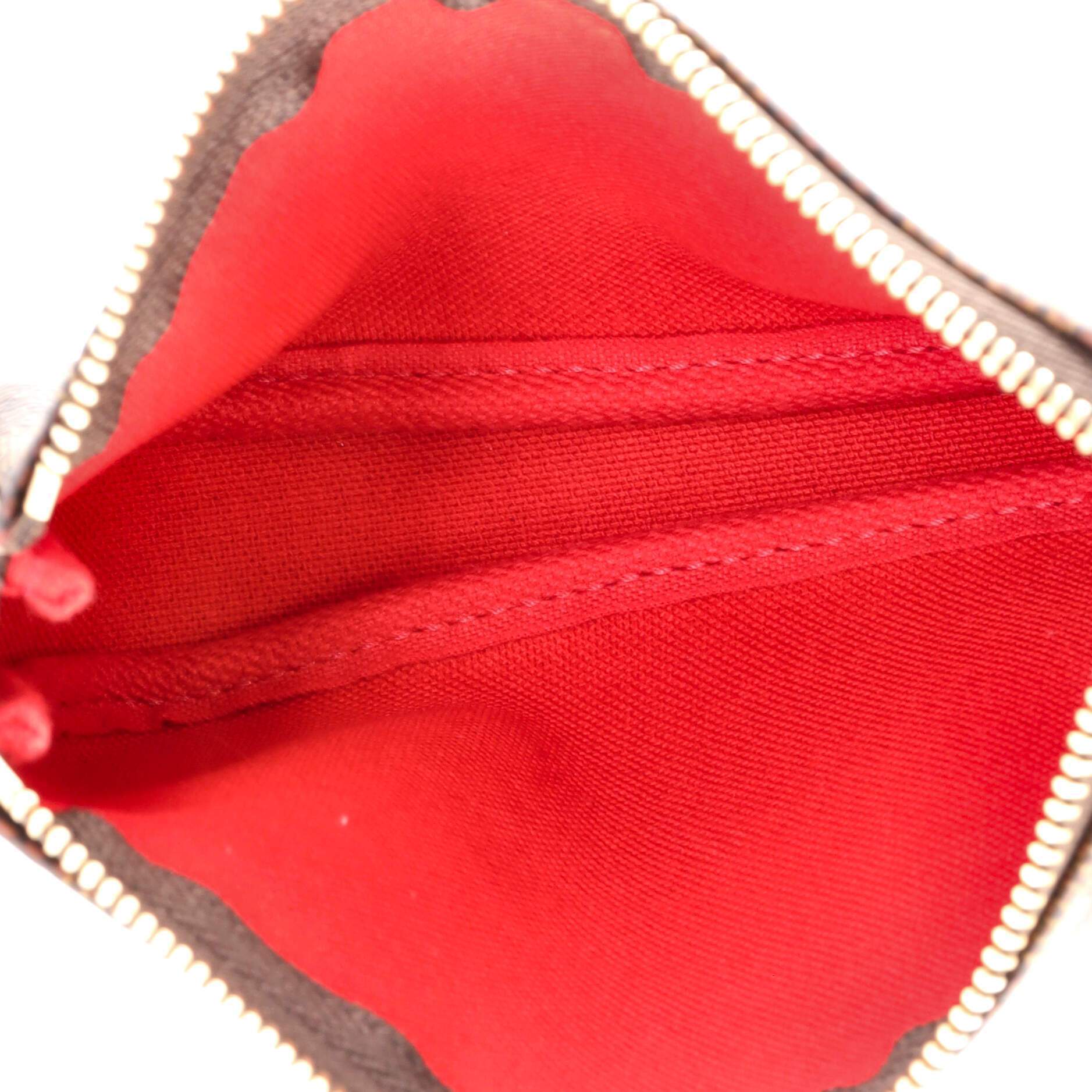 The pouch being held in a hand, showing its compact size