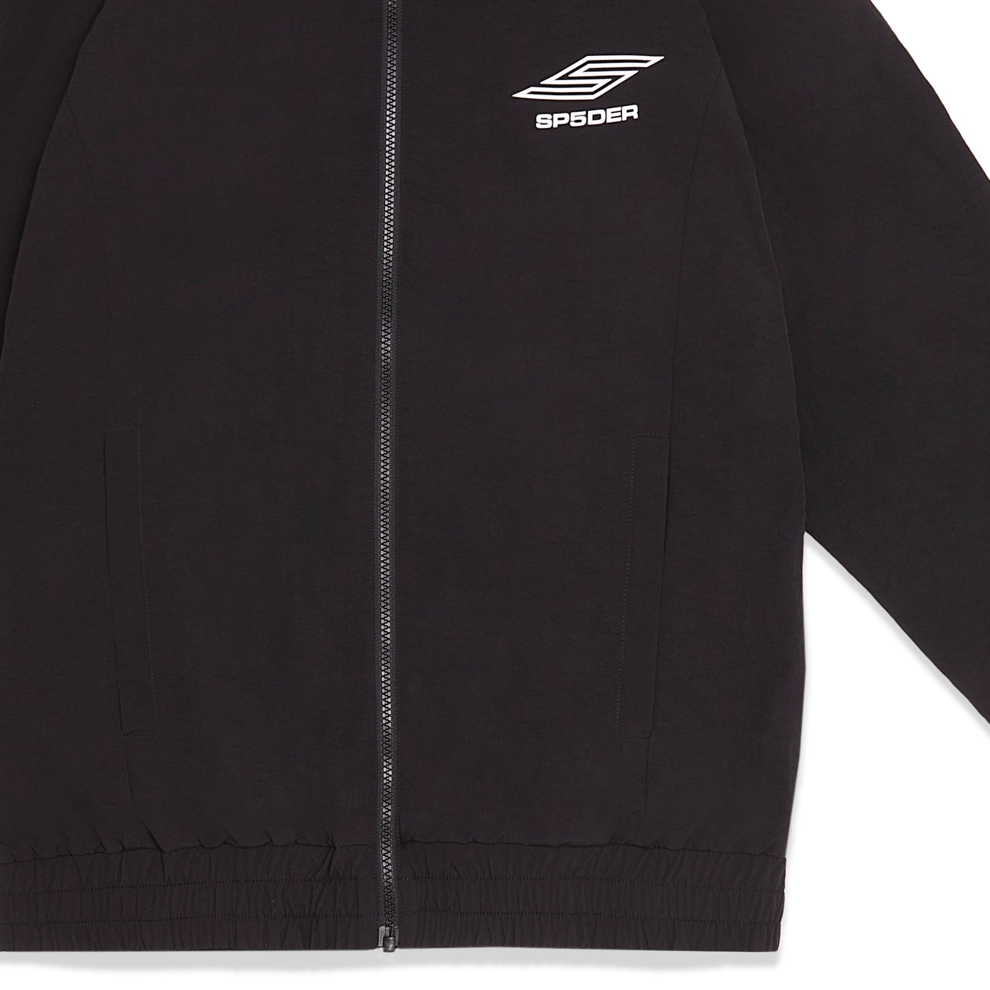 Detail view of SP5 Pro logo on SP5DER Pro Windbreaker in Black