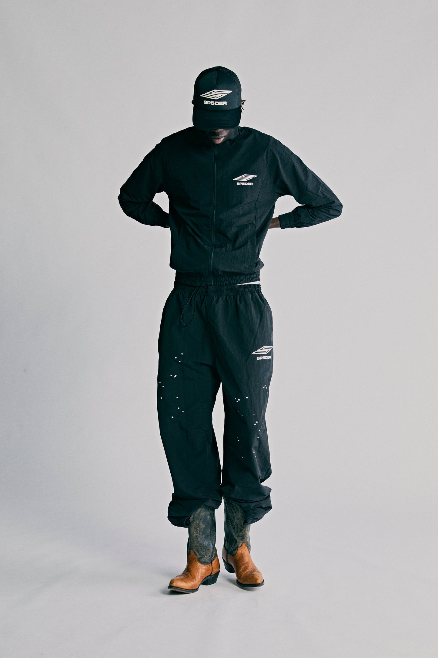 Model wearing SP5DER Pro Windbreaker in Black detail view