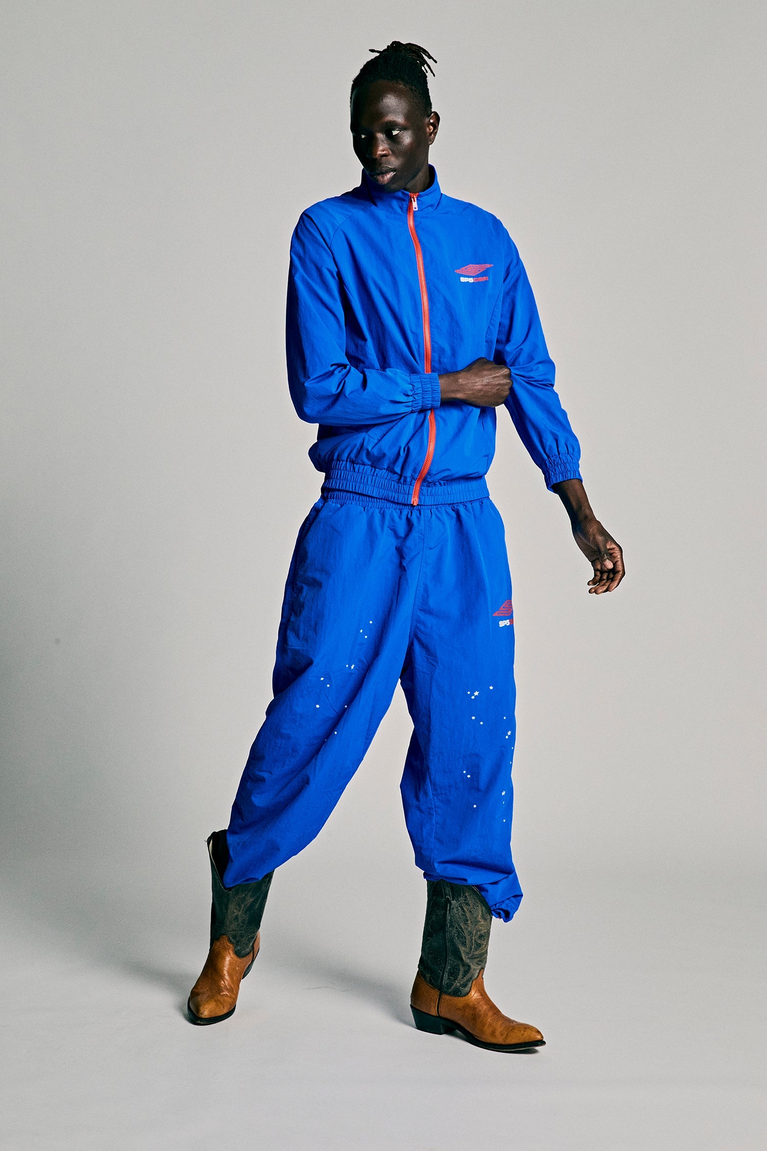 Model wearing SP5DER Pro Windbreaker in Blue detail view
