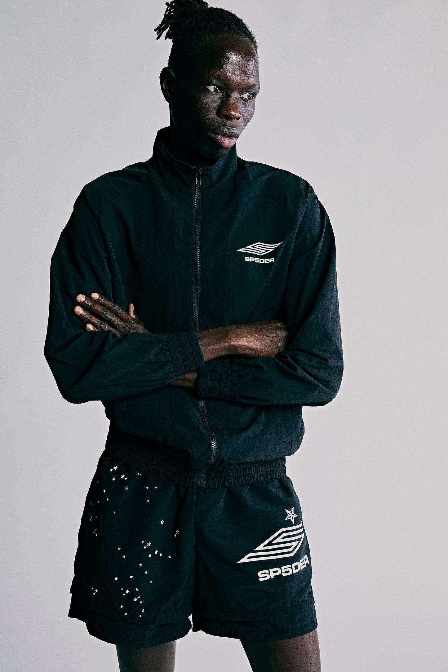 Model wearing SP5DER Pro Windbreaker in Black back view