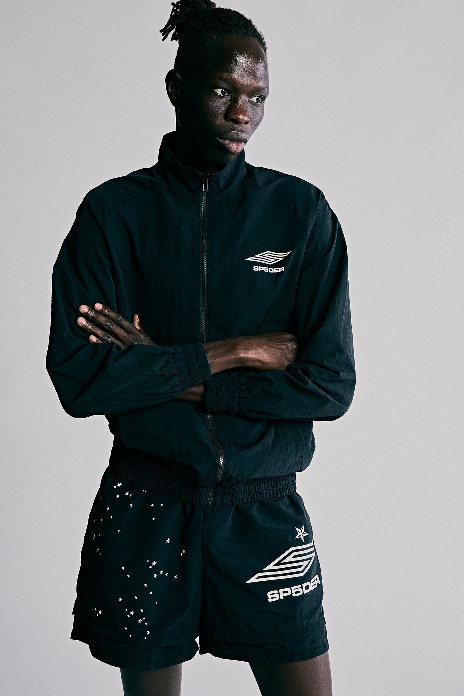Model wearing SP5DER Pro Windbreaker in Black back view